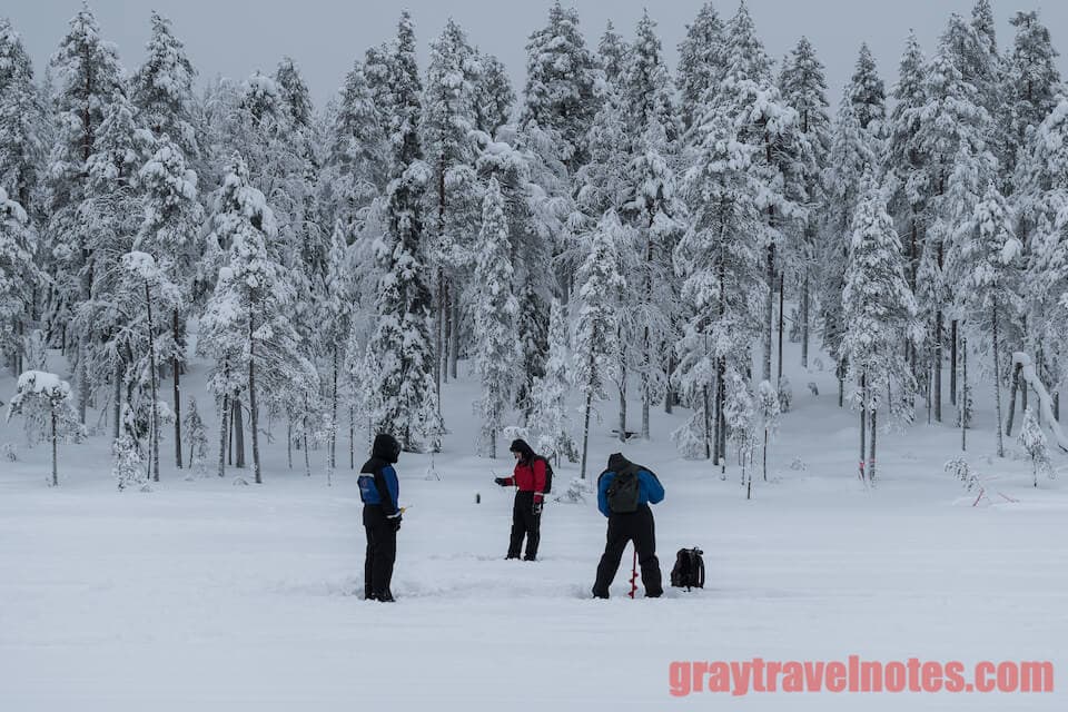 A candid shot of everyone trying out the ice fishing! - Gray Travel Notes